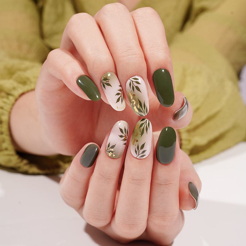 Olive green gel nail wraps with white botanical leaf nail art on manicured hands