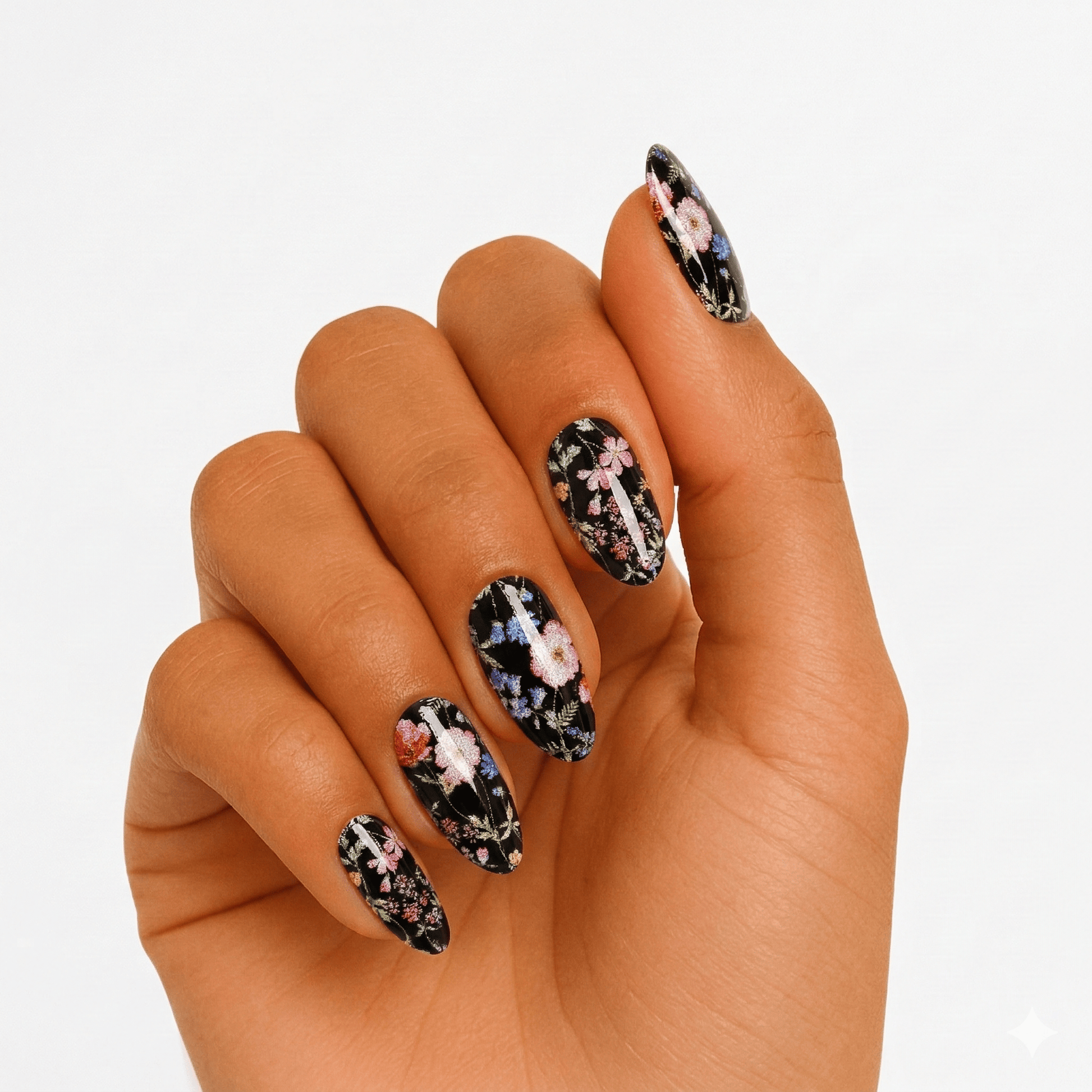 Black floral gel nail wraps on hand showing gothic botanical pattern design