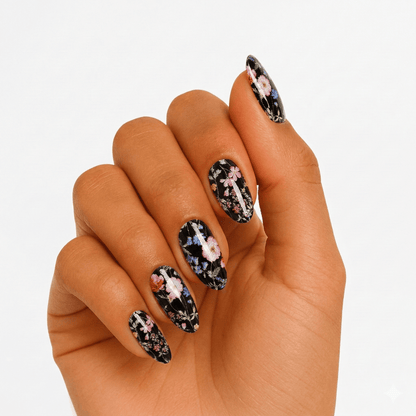 Black floral gel nail wraps on hand showing gothic botanical pattern design